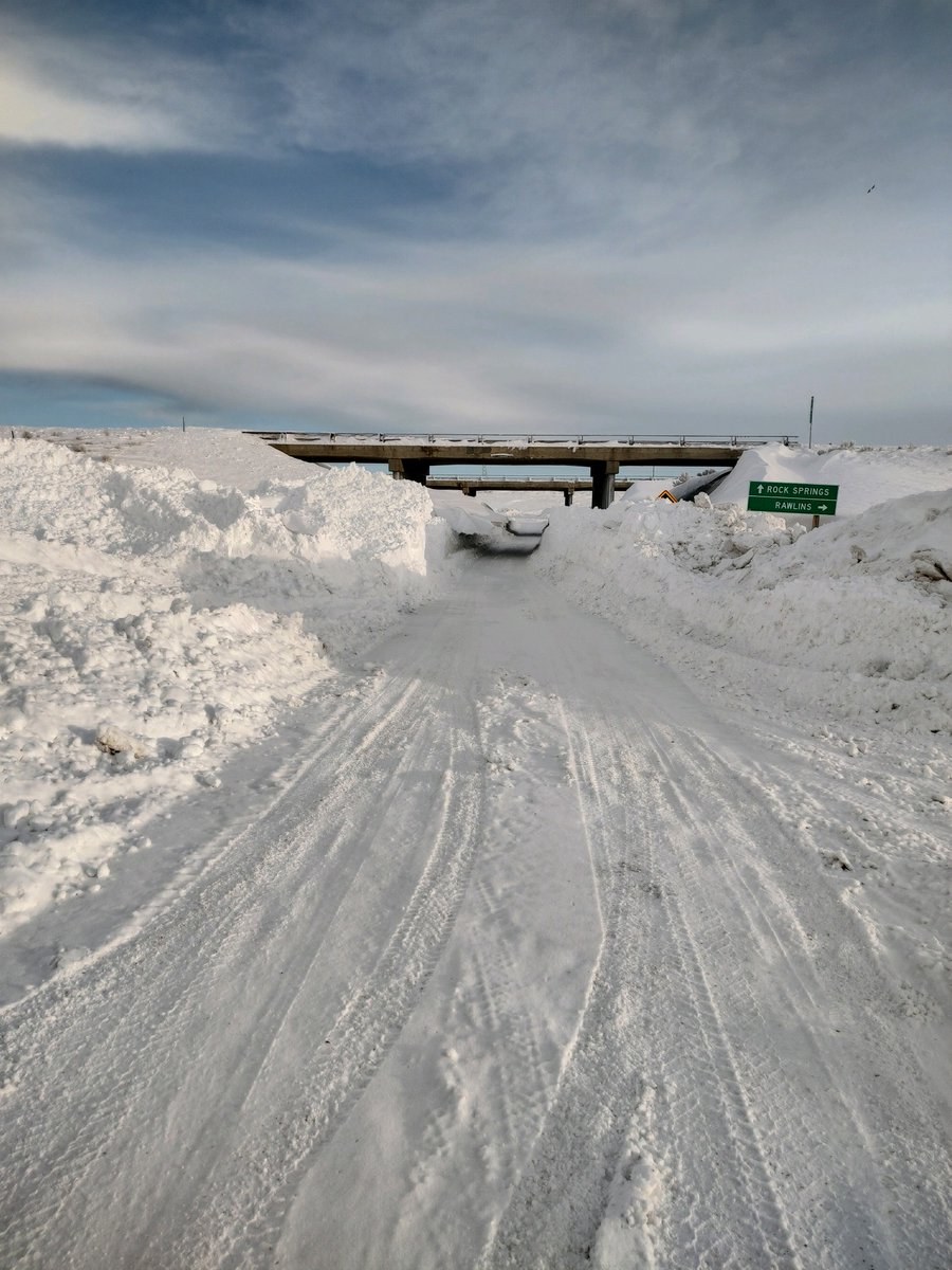 WYDOTNews's tweet photo. I-80 now open WB. watch for slick spots, blowing &amp; drifting snow. Some interchanges, esp. rural interchanges, may be covered in snow &amp; exiting is impossible. 
Crews continue work on the drifting EB. Photos show I-80 drifting between Rawlins &amp; Rock Springs  #wyoroad https://t.co/7tkQQ2ywFW