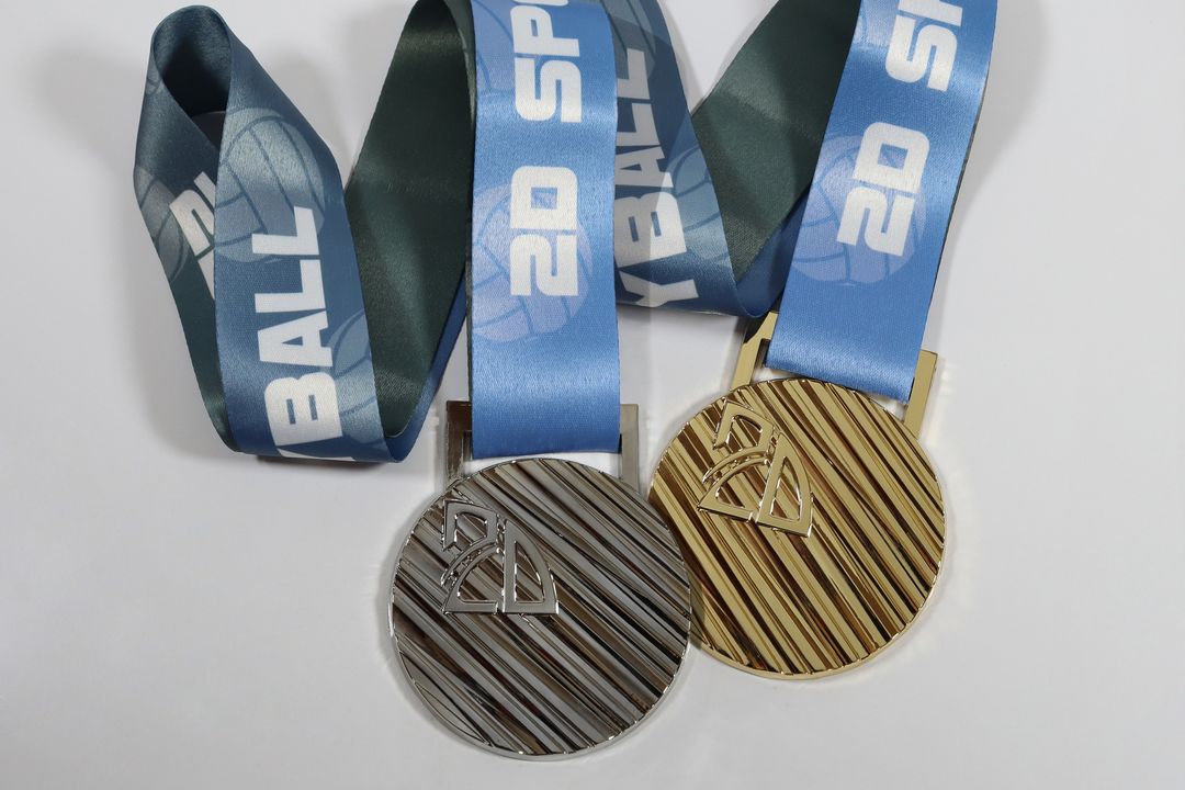 2D Sports Volleyball hosted their club tournaments earlier this year and had SymbolArts make these silver and gold medals. #symbolarts #symbolartsmedals #medals #custommedals