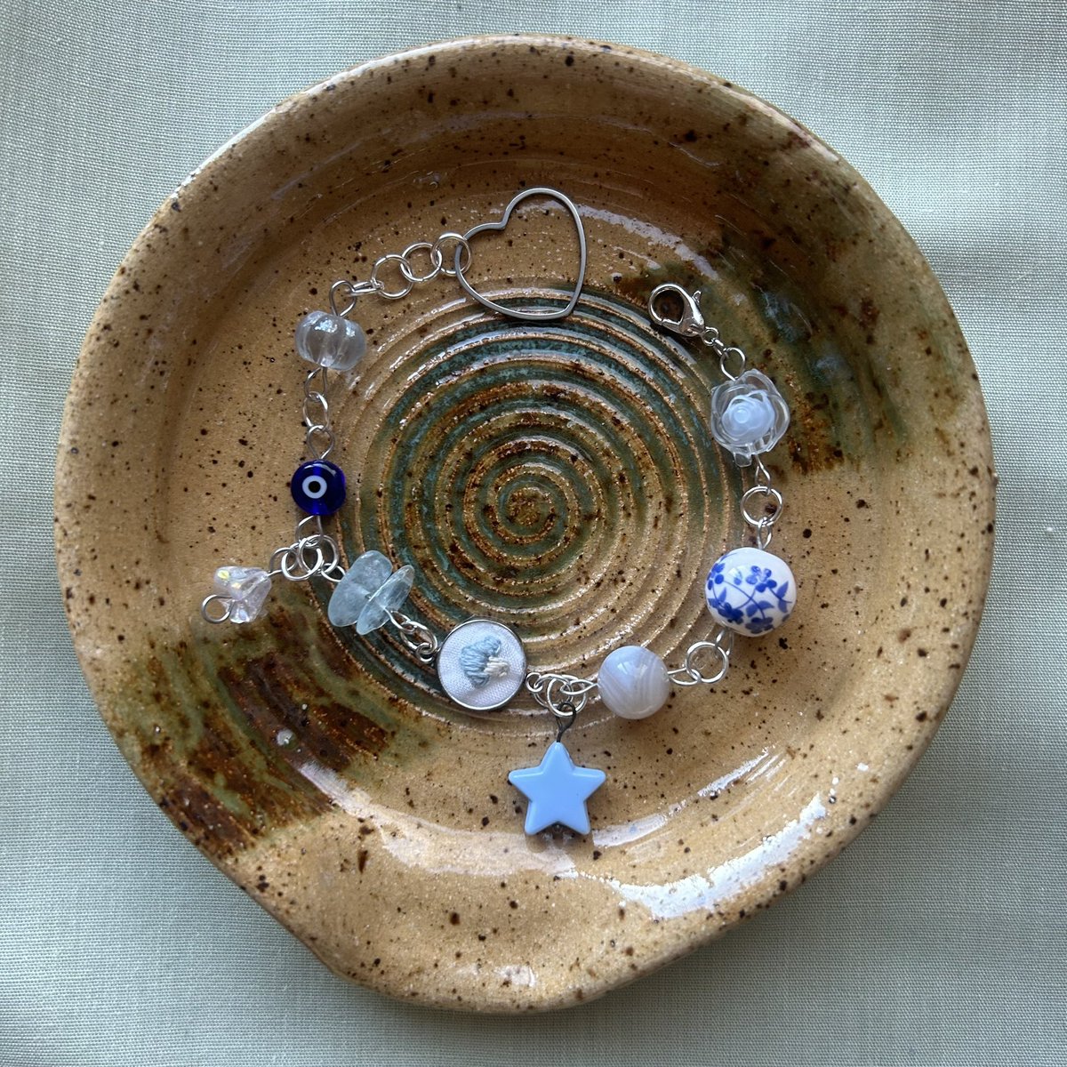 thepeachstitch's tweet photo. 🌷 made the first ever peach stitch bracelets this morning &amp; i am fully obsessed with each one <3 if u are too, u can find them in my sh0p tmrw @ noon pst 🫶🏻 ft. handembroidered pendants &amp; natural crystal, glass + porcelain beads! 🌿 https://t.co/QfXUwMh5S9