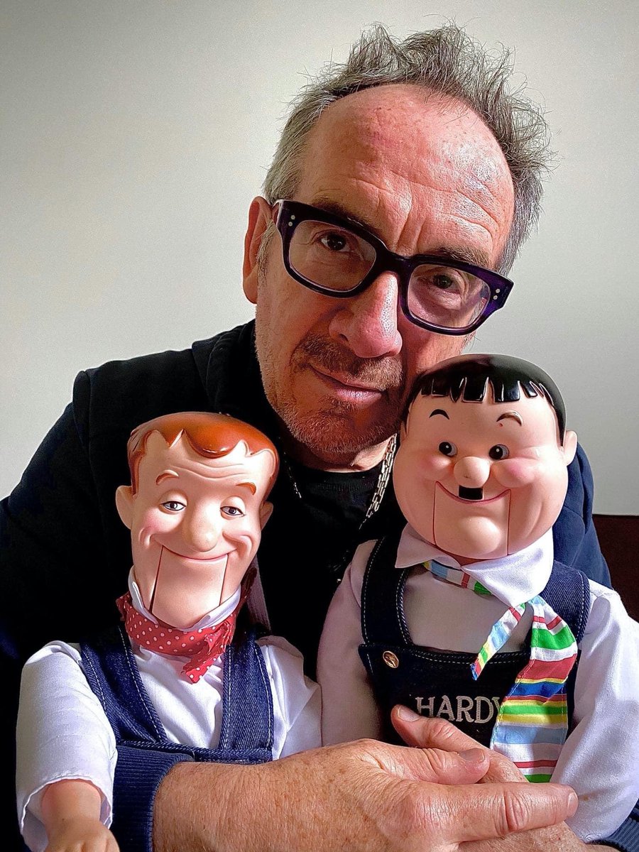 JimLNeibaur's tweet photo. OK, a pic of @ElvisCostello holding Laurel and Hardy puppets is all I needed to see today.  I will hereafter insist that Oliver's Army is about Hardy. https://t.co/ODSPG1wbCg