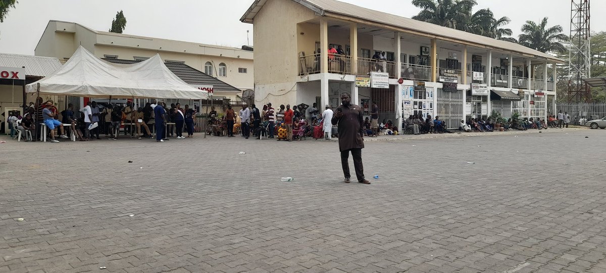 winkari's tweet photo. Polling unit 018 locates at Zone E Legislative quarters Apo, as at 12 noon INEC officials are yet to arrive. Voters and party agents are waiting for their arrival.

Electorates express their  displeasure over the delay. But are patiently waiting. https://t.co/nM0uDgT5ig