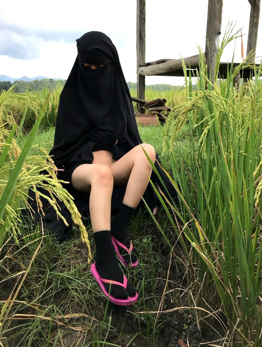 A woman in a vibrant pink dress captivates with a seductive gaze a hint of mischief in her eyes.