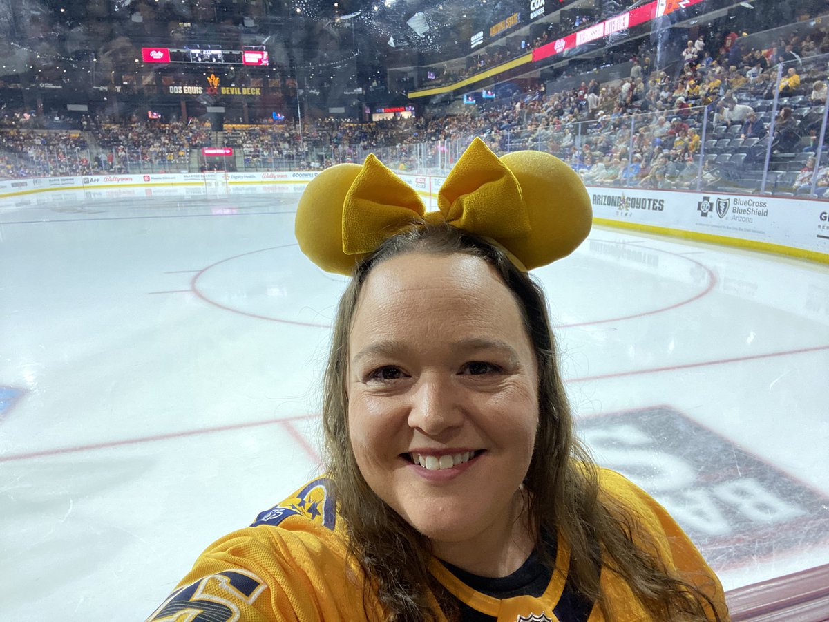 PredsSigns's tweet photo. So I attended the game tonight in Arizona! You may have seen me wearing gold Mickey ears on the glass behind the goalie on the left. It was A LOT of fun! Wish the outcome had been better. Their arena is laughable. Tiny and you can't even walk all the way around the concourse haha https://t.co/cdblTn23FM