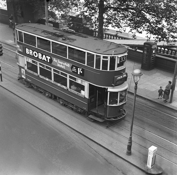 33 tram travelling in London with an advertisement for brobat bleach running down the side of the tram 