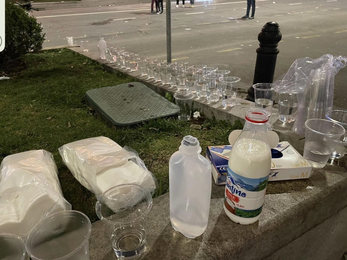 antelava's tweet photo. 3 great photos from #Georgia protests (not mine): Water &amp; milk put out by protestors to use when pepper sprayed. A msg on a rock thrown at police that reads “Forgive me. Please be on the right side of history. Be our hero ❤️”. And the final and the best one ⬇️ https://t.co/jmq3nkI33B