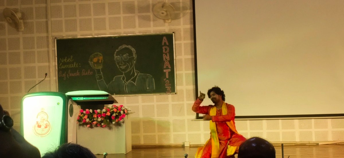 As people says, @bhupro = science+spirituality+ culture 
You can see in this pic, in board, portrait of Nobel laureate prof. Svante paabo  and traditional dance of India on stage. 

First day was full of outstanding lecture by many professor with diverse topics. 
 
#ADNAT2023