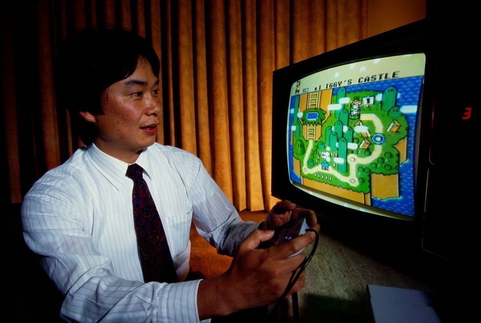 Shigeru Miyamoto, creator of Mario and other characters and video games for Nintendo, plays Super Mario World on a Nintendo Super NES. Mario Day is celebrated on March 10 (Mar10) (Tokyo, Japan 1992)