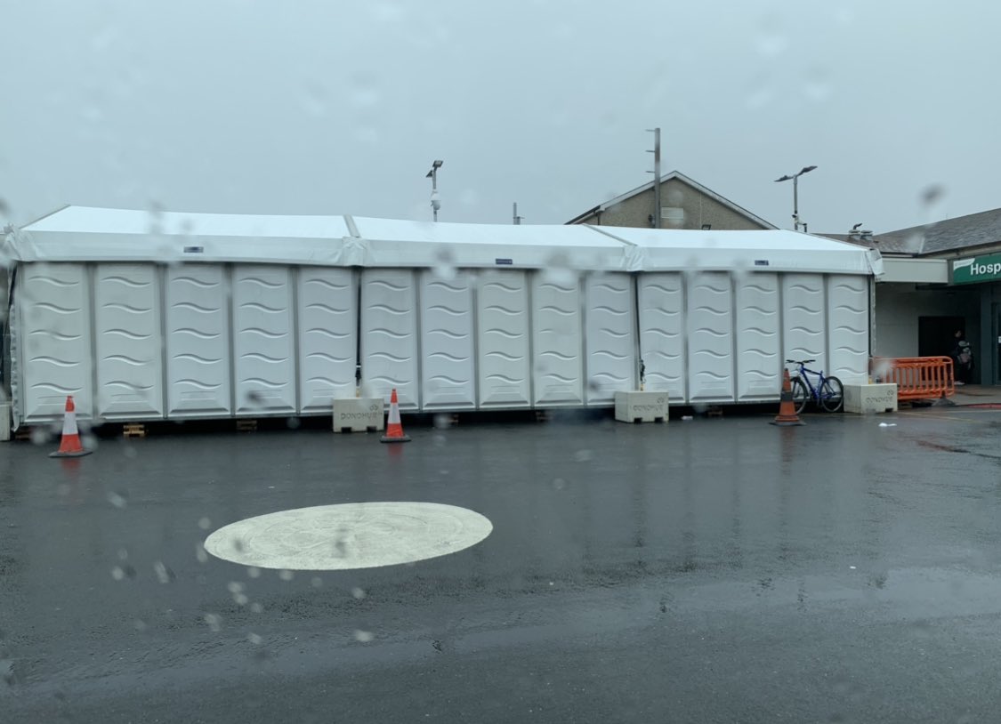 MattShanahan1's tweet photo. Temp tent added to temp modular A+E unit at UHW- catering to closed Wexford ED referrals.. Construction of promised outpatients unit at UHW now 3 years overdue! / No Funding approval...NOTHING TEMPORARY about the PERMANENT HSE BULLSH*TE ON VIEW at UHW @IrishTimes @wlrfm @HSELive https://t.co/fOmBhjX173
