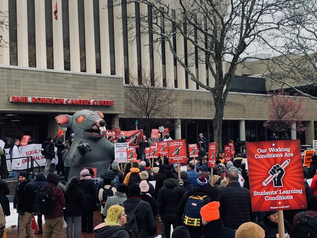 THEM: home on zoom trying to avoid the #StrikeWave – US: standing happily together in the cold in solidarity with our students, the  community, & members from the all the unions representing the more than 20,000 workers working w/o a contract for 8+months. We are not the same.