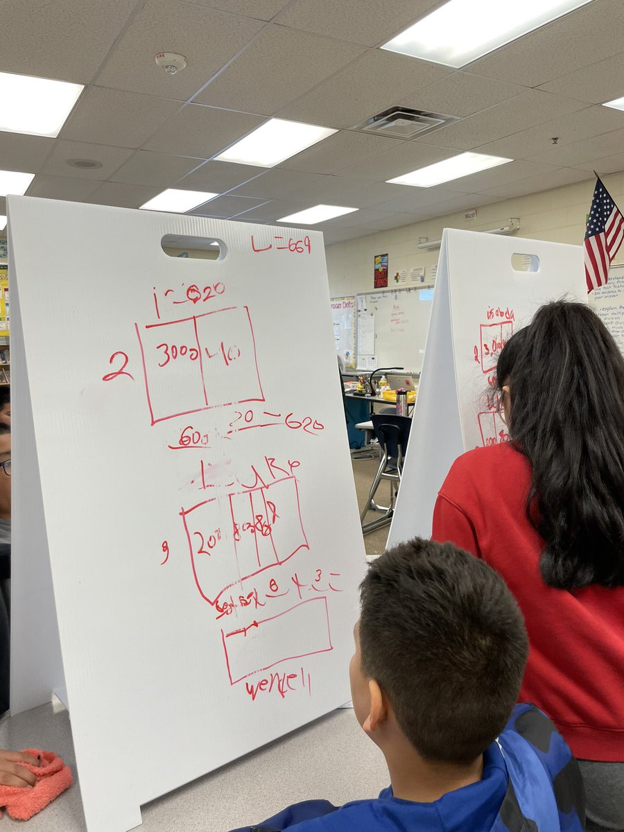 patsyacorn's tweet photo. Fourth grade teams solving division problems. @HowardGI https://t.co/uYXBk5S3mA