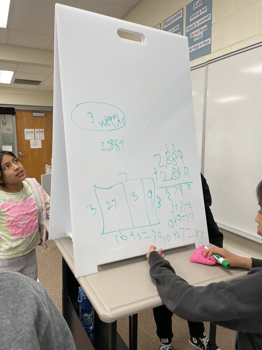 patsyacorn's tweet photo. Fourth grade teams solving division problems. @HowardGI https://t.co/uYXBk5S3mA