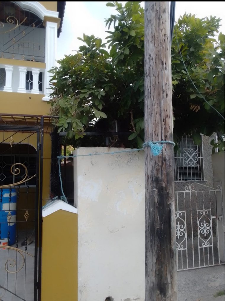 Waterford4JLP's tweet photo. @J_P_Service, this is what we have to do in Waterford, Portmore: We tied up the Utility Post to prevent is from falling down. 

When will you respond to us? 

@CVMTV @NationwideRadio https://t.co/x2ShP90ID6