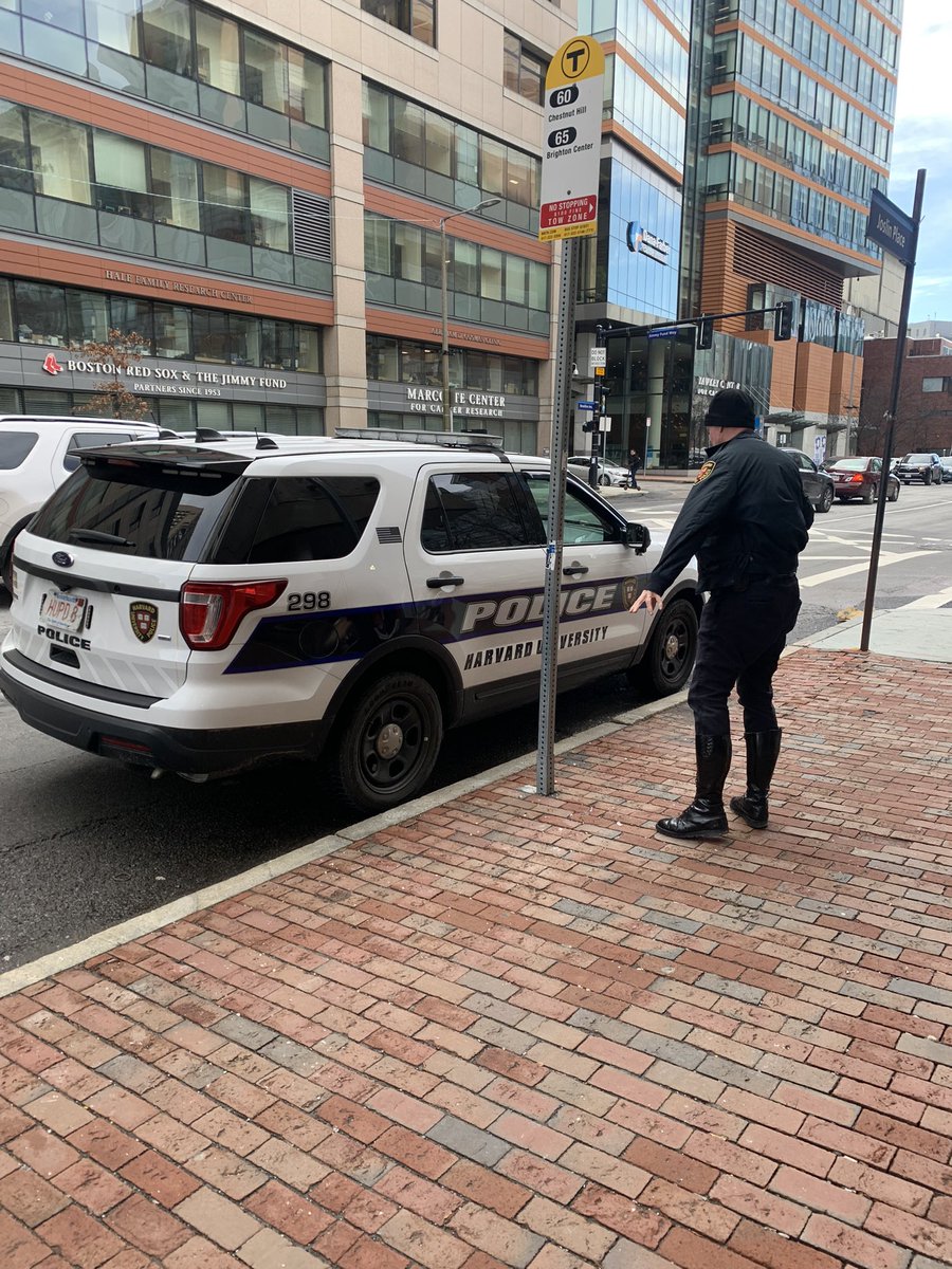 EvanMacIsaac's tweet photo. Hey @HarvardUniv (and @mbta) any reason your officers need to park in bus stops so they can go to the bank? Longwood traffic is brutal enough as is. https://t.co/4gh4GKHmTO