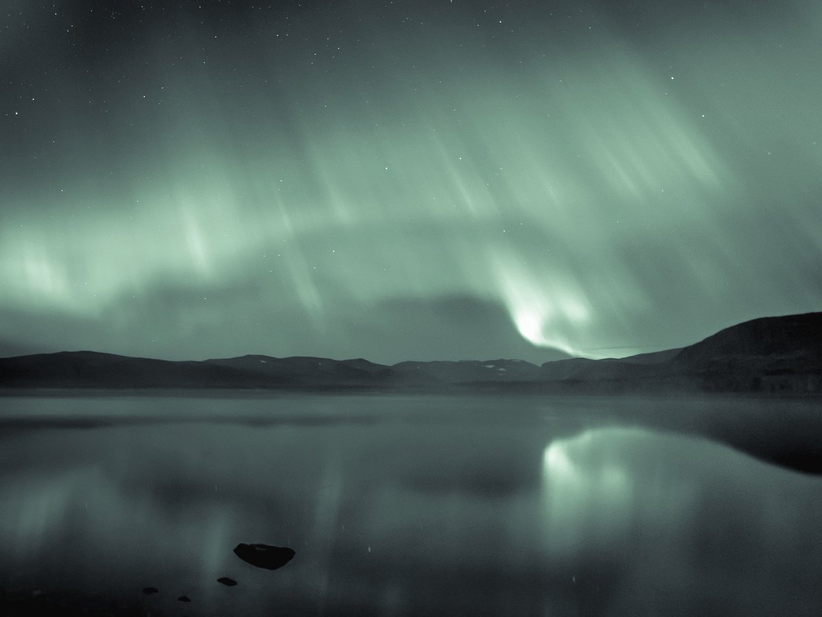 Seeing the aurora over calm open water, in complete silence, is a truly ethereal experience. 
The window of time in fall before the snow comes and lakes freeze is an amazing time for stargazing. Watching the sky and it's reflection with the mist rising off the water in between.