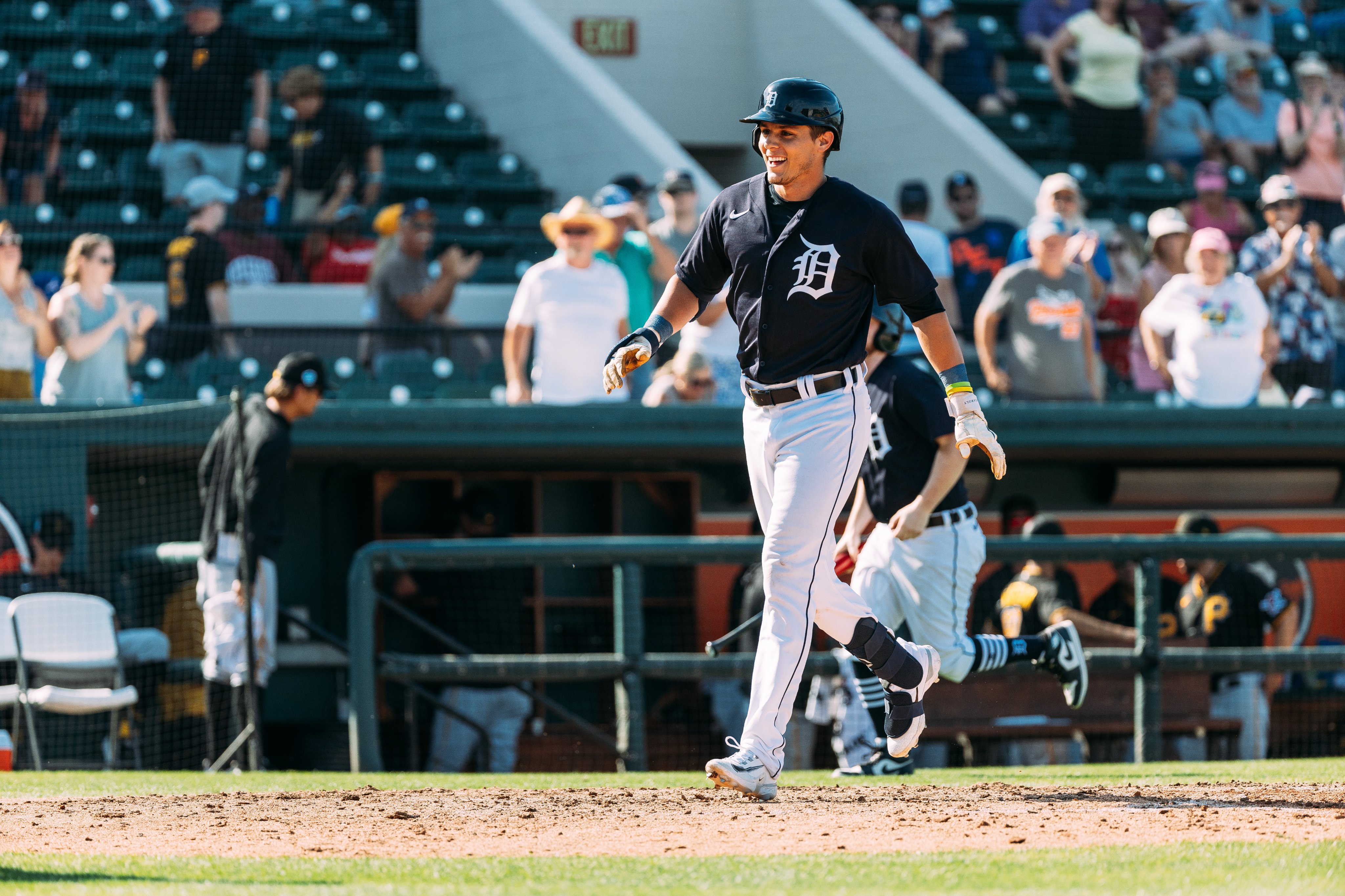 Nick Maton smiles as he approaches home plate following his walkoff home run