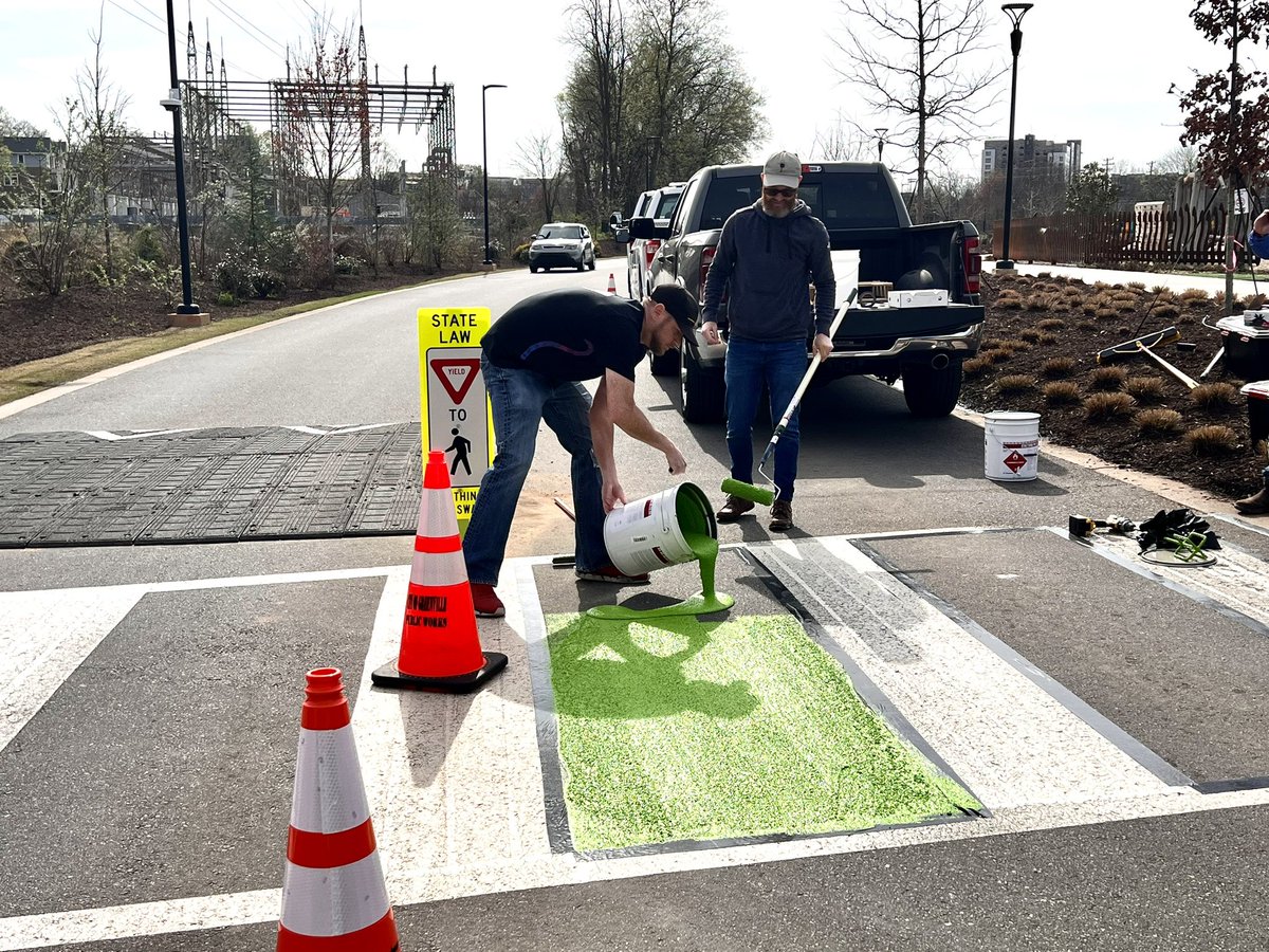 Going green! 🚴 Today, a vendor for a pavement marking product installed green on this Unity Park crosswalk to test its durability, application process and aesthetics for the City. This pilot location was chosen to help make this crossing location more visible for park users.