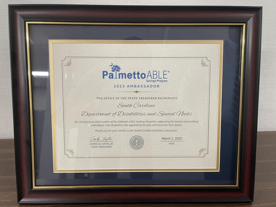BHDDOIDD's tweet photo. State Treasurer Curtis Loftis honored DDSN and 21 Palmetto ABLE Savings Program Ambassadors. DDSN is an advocate for the Palmetto ABLE Savings Program, a tax-advantaged savings program for individuals with disabilities. Interim Director Constance Holloway, accepted the award. https://t.co/IDzsAHtmJ7