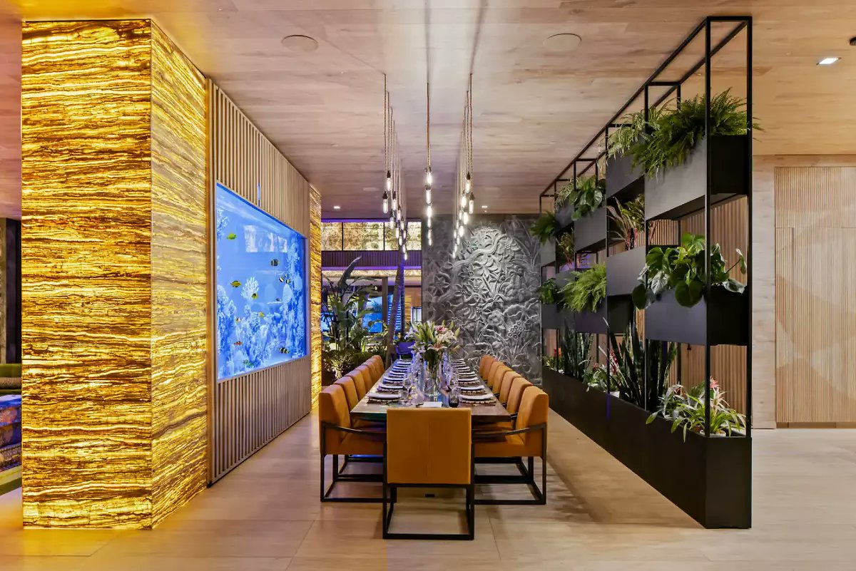 JustAskJudyR's tweet photo. The modern glass-and-concrete architecture is built around an open-air courtyard with lush palms and a koi pond. https://t.co/L8xBu9coD7 https://t.co/PajJMmmKyo