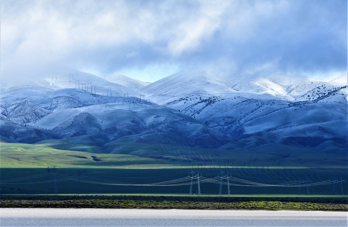 PGE_John's tweet photo. There is a fierce beauty in the Carrizo Plain. I've never been during winter, but always during summer when triple-digit temperatures bake the ground. This stunning location is known for its vast open grasslands, wildflowers, and unique geological formations. It has been transformed by winter rains and snow, bringing new life and colors to the plain. 🌧️❄️ @VisitCA