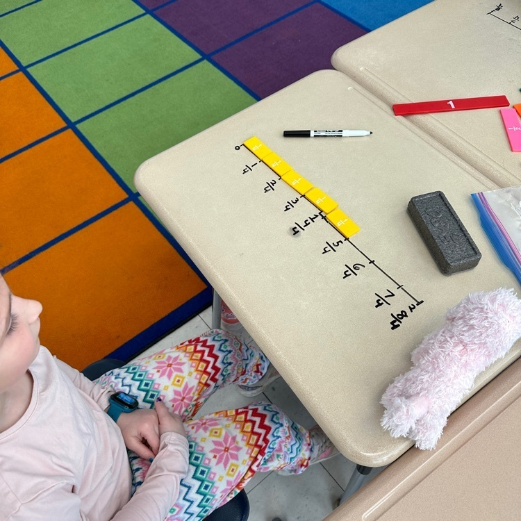 WPSCoolidge's tweet photo. "We can write on our desks?!" Students had fun using fraction strips and drawing number lines on their desks to practice identifying fractions on a number line! https://t.co/qQG9rShxP1