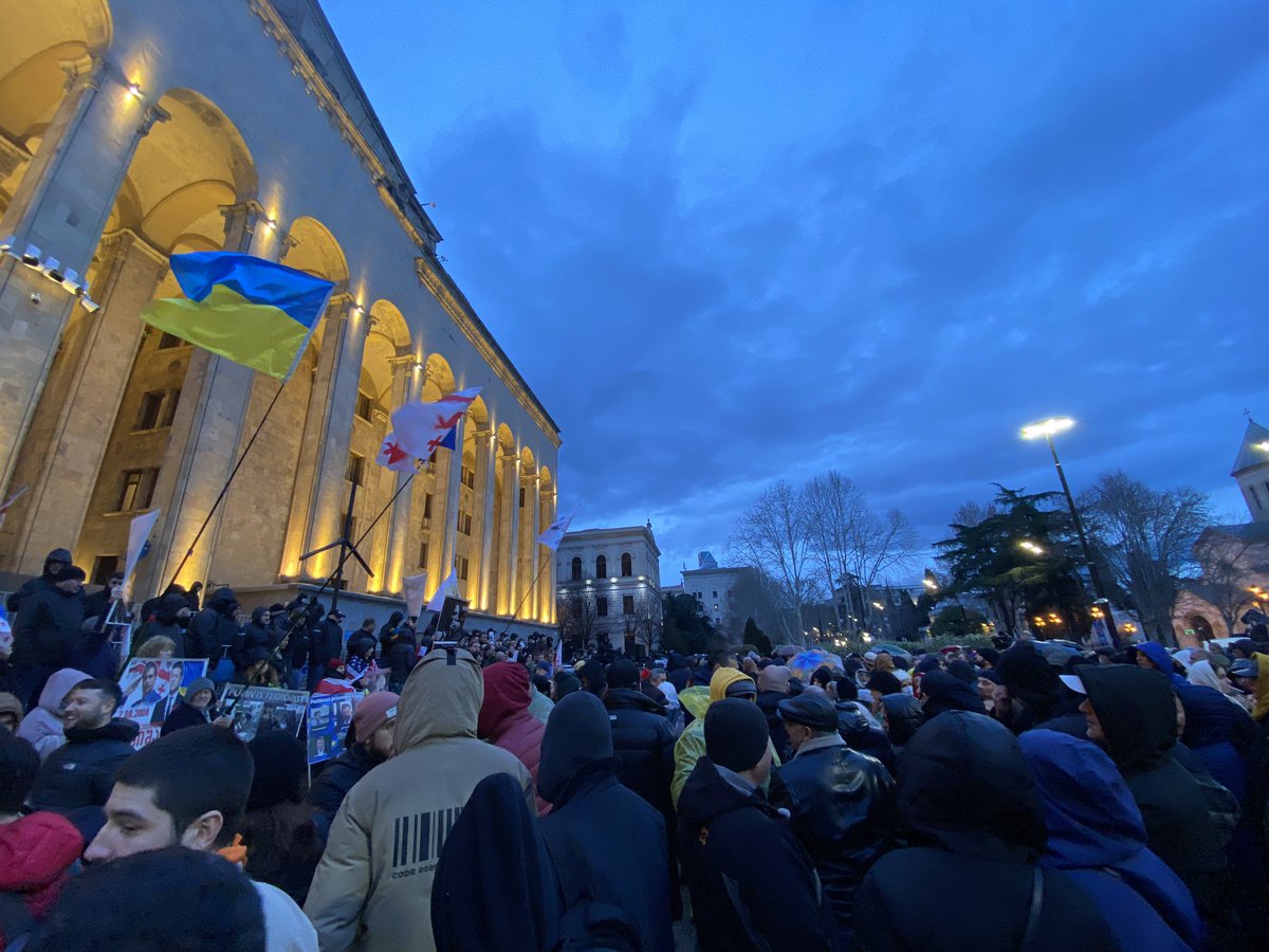 Helenkhosh's tweet photo. After clashes at the Parliament earlier today to protest the Russian law (foreign agents bill), people are gathering spontaneously. MPs were dragged by force out of the chamber, and the GD proceeded with the hearing with a delay of 90 minutes and thanks to brute force. #Georgia https://t.co/UtJCr3qtUZ