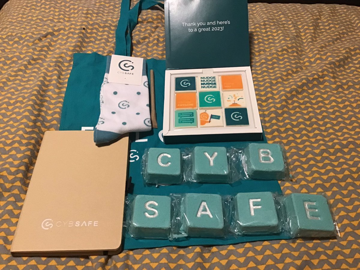 johnmcalaney's tweet photo. Over the years I have on occasion been given a gift bag after giving a talk at an event. These are, to blunt, often a bit simple. Fair play then to @CybSafe for the lovely gift bag containing marshmallows, bath bombs and a pair of cybersecurity socks. https://t.co/W1GWJxeZEn