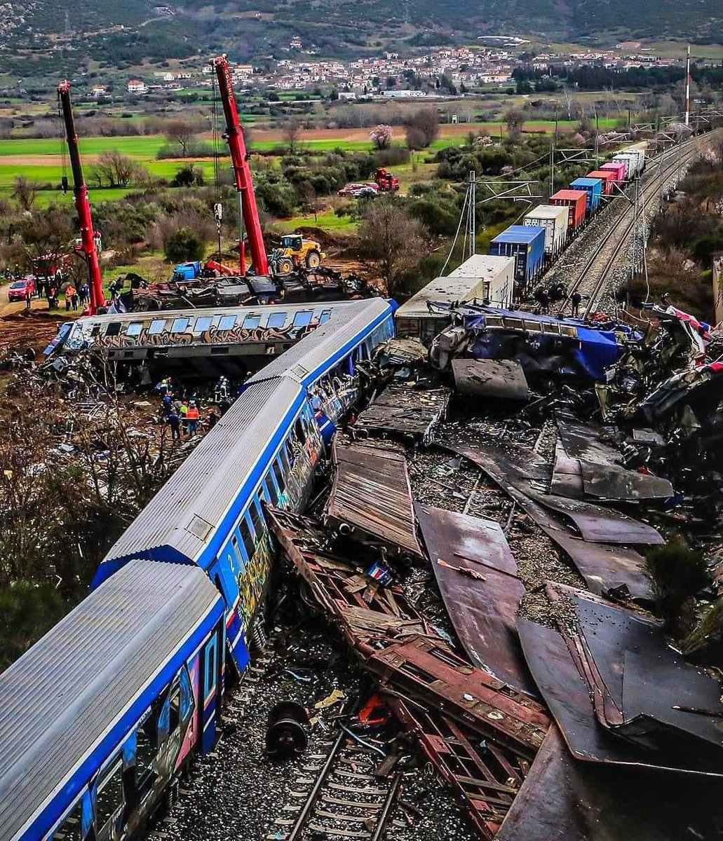 EChristofi's tweet photo. Our thoughts and prayers to all the families who lost loved ones in the fatal and tragic train collision in Greece.  A passenger and freight train were involved in a fatal traffic accident in #Tempi near Larissa, with at least 50 dead, hundreds injured and missing.  ⬇️ https://t.co/IoVOADD6Im