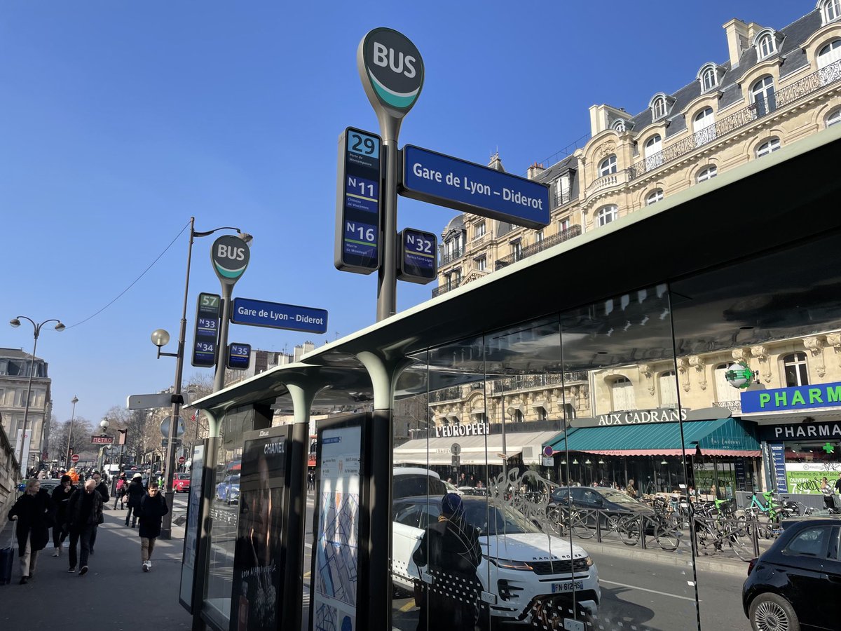 humantransit's tweet photo. Your friendly reminder of what a bus stop sign in Paris looks like. Under each number is a tiny display showing the number of minutes to the next one. Lit up at night of course. https://t.co/Ovb1fGj4UX