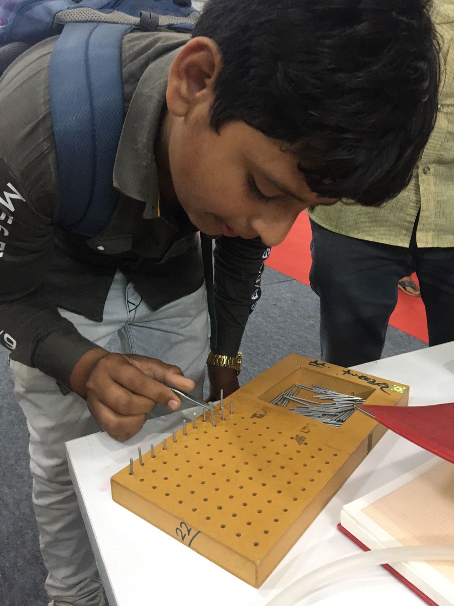 Students trying their hands on the cognitive tasks (block design test & pegboard test) employed for cognitive evaluation of the workers, displayed at @icmrnioh stall as part of scientific exhibits on day3 @GujScienceCity during #SC2023 #ChaloScienceCity, #ScienceCarnival2023