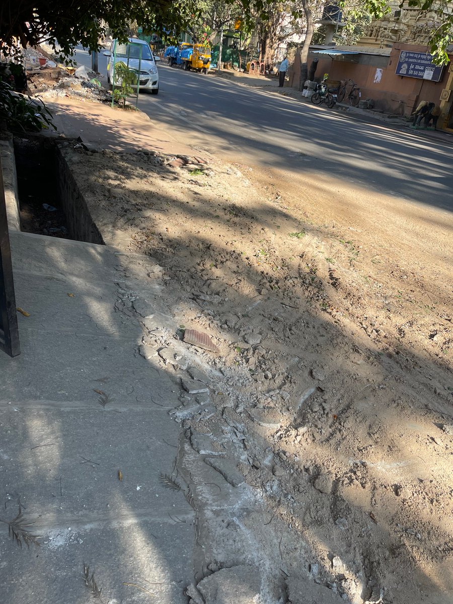 SidDebV's tweet photo. Sidewalks and rainwater drains opened for cleaning. Debris removal is moving at a snail's pace and now this in Koramangala 1st Main, 1st Block. The sidewalk up to the driveway is torn up.  @BBMPAdmn @BBMPCOMM @swaccha_bbmp #BBMP @VOfKoramangala https://t.co/r3hbfuGjfp