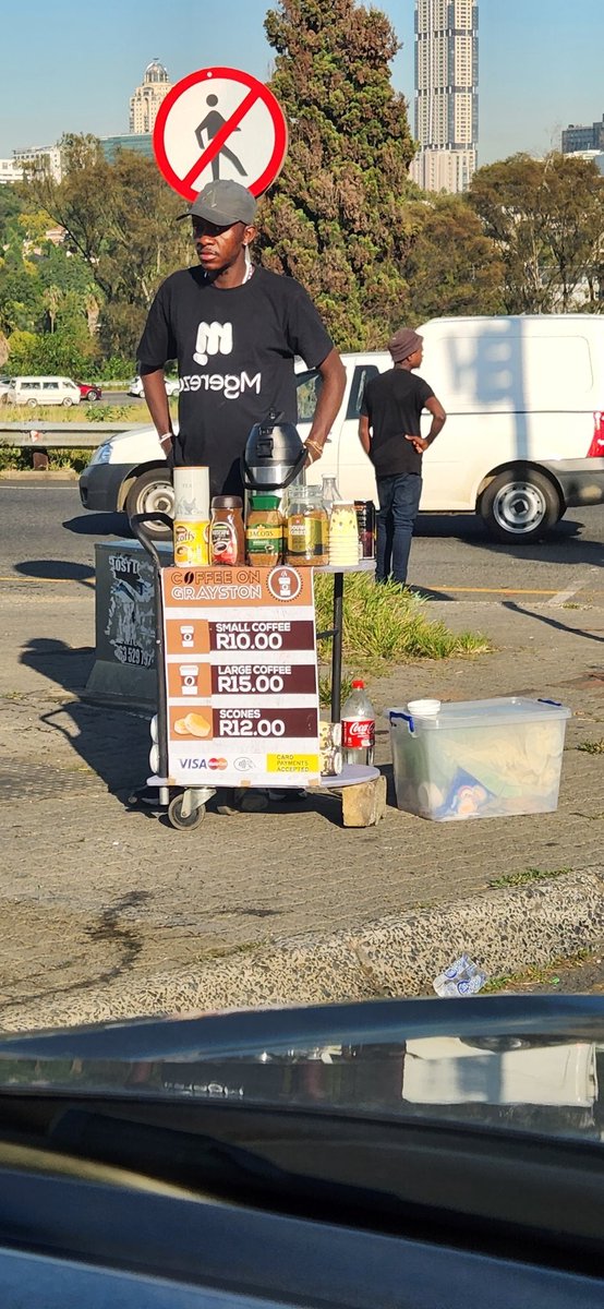 This guy sells scones &amp; coffee at the Robots Section, Grayston, Sandton. 

He also has a loyalty card. After 5 cups, you get the 6th one for free.

You can also call him when youre couple of minutes away from the intersection, he’ll make the coffee &amp; have it on standby.