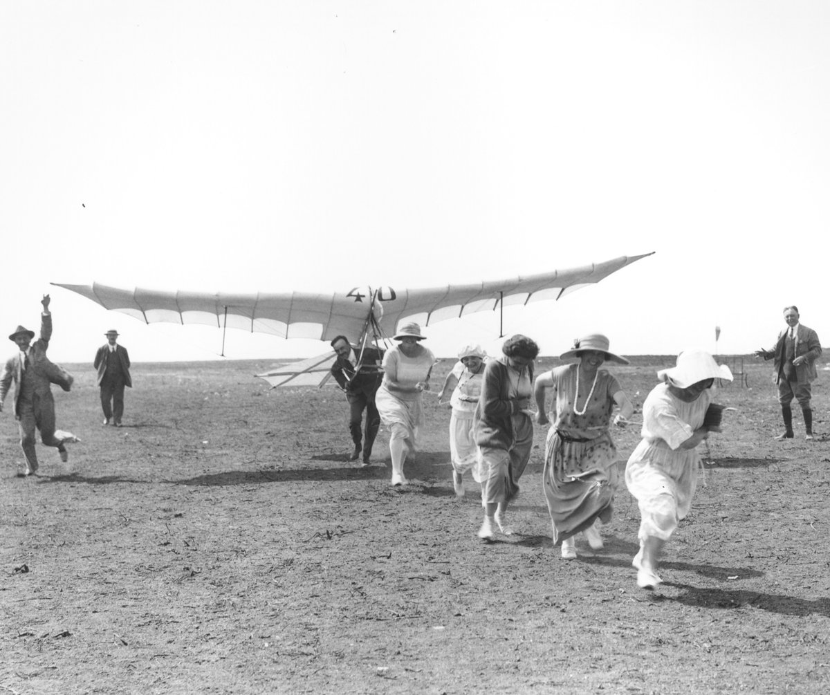 RAFMUSEUM's tweet photo. #CuratorsPick : Monsieur Henri Mignet with his glider, the Mignet HM.5, while attempting to launch during a glider and light aeroplane meeting at Vauville, Normandy, in August 1923. Not sure the five ladies 👒 provided enough power to launch it! 😀😜 https://t.co/Ie1rYsFBDu