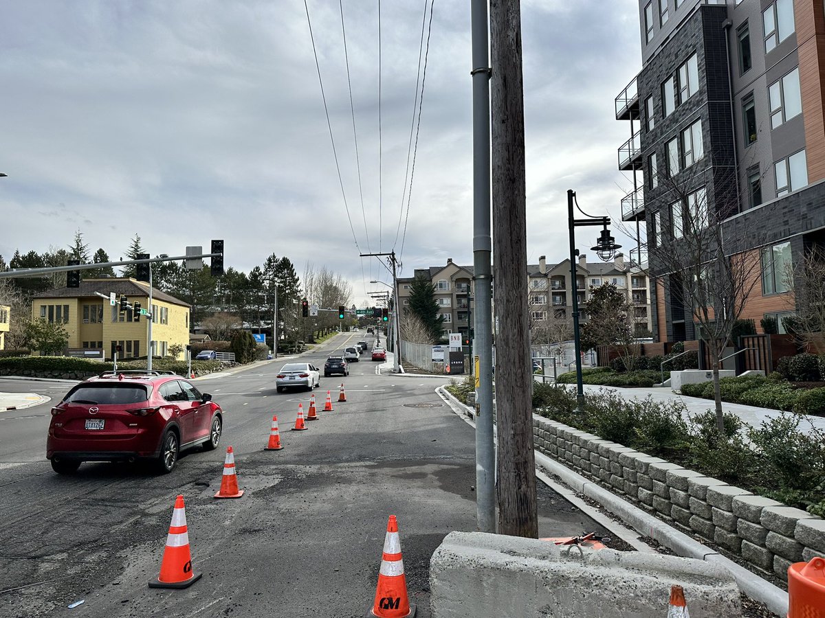 Finnhillian's tweet photo. At @KirklandUrban. New bike ramp. Dedicated bike lane awaiting completion. Many projects delayed due to staffing issues at PSE, so electrical utilities taking months to complete. https://t.co/l4S1YSAHxd