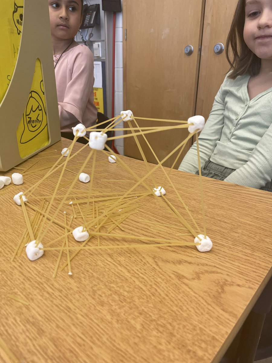 Building structures and discovering how struts and ties work! After adding ties this structure held 7 books!