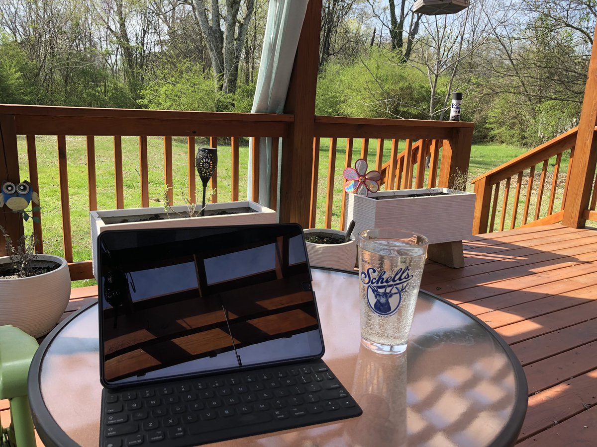 karenbabine's tweet image. Class prep in the outdoor office where I remain confused by the baby strawberries on my plant. It’s March, you fools! #spring #amteaching