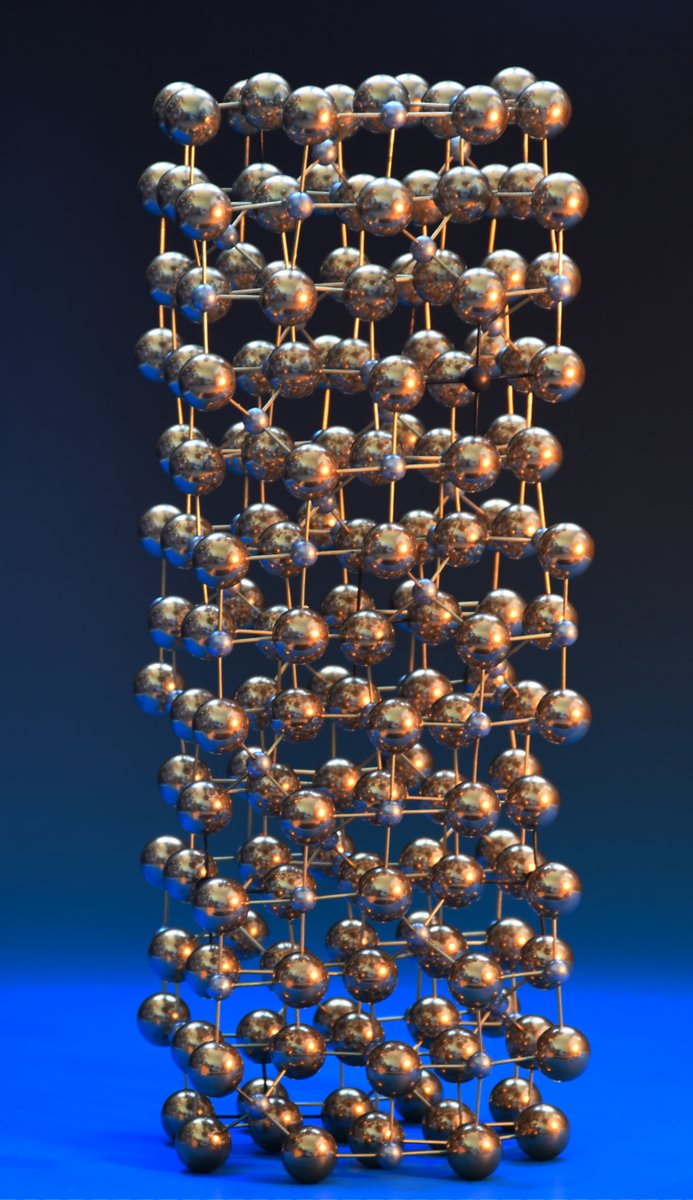 Miramodus's tweet photo. g-Al2O3 structure isn't well-characterised, but based on the AB2O4 spinel. B-site vacancies correct the stoichiometry.
15mm brass = O-atoms, 7mm aluminium= aluminium atoms. Vacancies are 7mm brass w/ a black patina. One of the most challenging #molecularmodels we've built. https://t.co/9A0daWzaZM