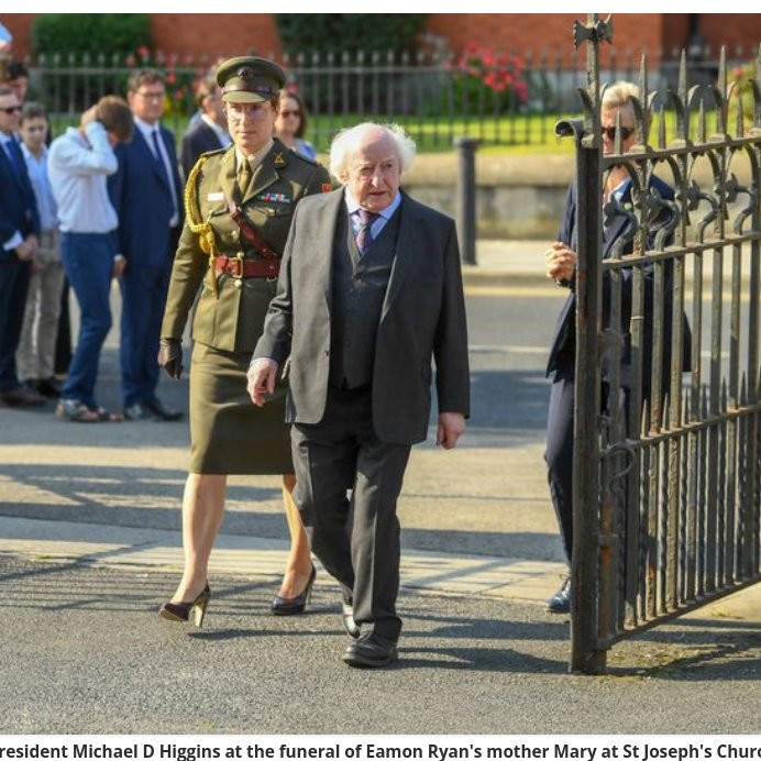 Is that a man in heals with Michael D at Eamon Ryans mother's funeral.. #Irisharmy