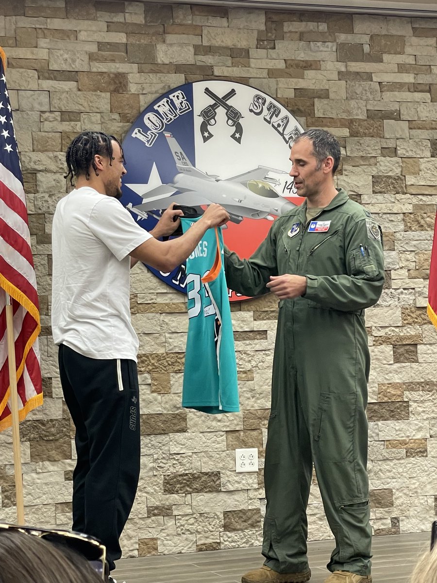 USAA's tweet photo. @USAA hosted @spurs point guard @Tre3Jones at the 149th Fighter Wing at JBSA-Lackland AFB today. He presented the unit with a signed jersey, tried on a flight suit and helmet, toured an F-16, and signed autographs.

Check out more at https://t.co/ESLPBG0ShJ https://t.co/qqmYRGzlyb