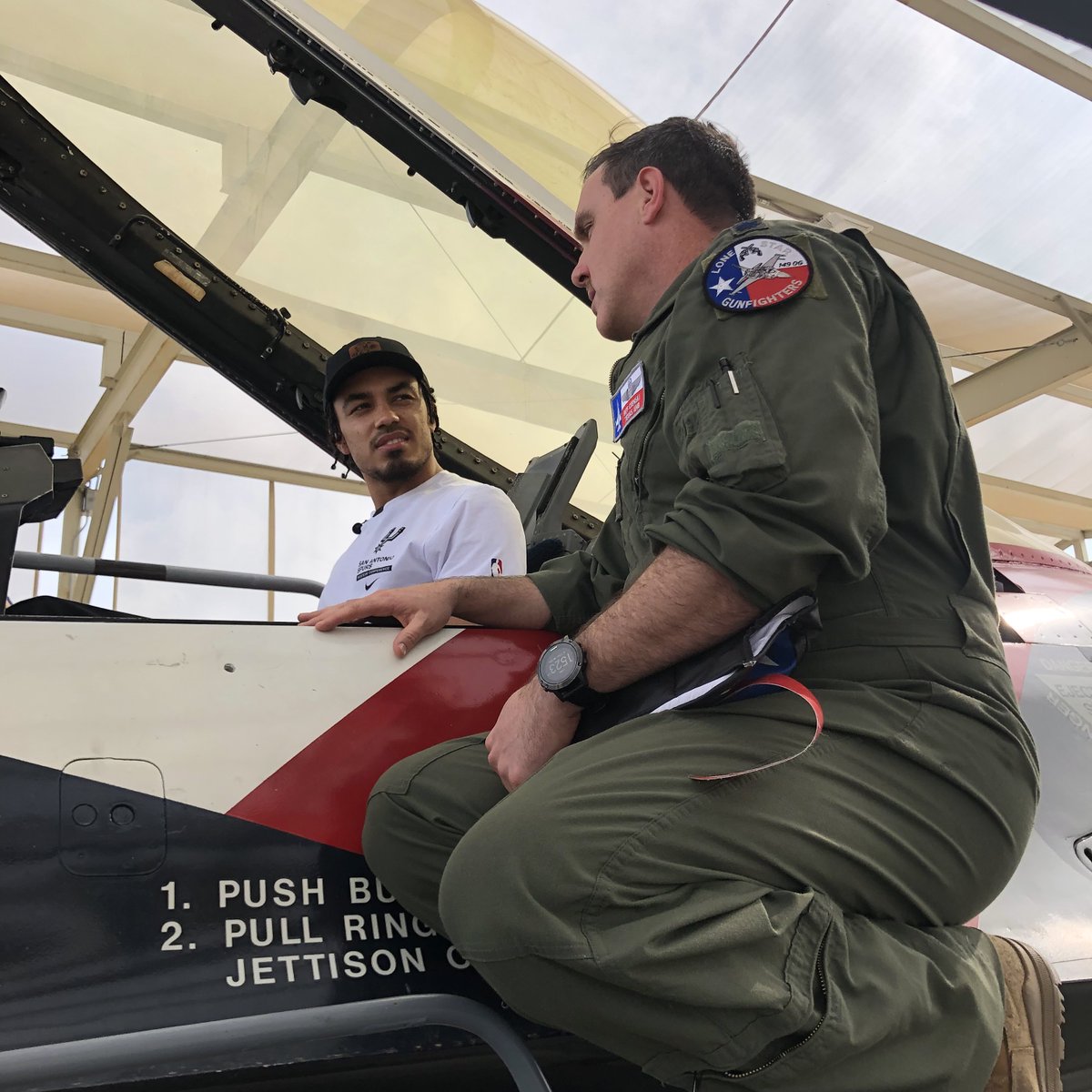 USAA's tweet photo. @USAA hosted @spurs point guard @Tre3Jones at the 149th Fighter Wing at JBSA-Lackland AFB today. He presented the unit with a signed jersey, tried on a flight suit and helmet, toured an F-16, and signed autographs.

Check out more at https://t.co/ESLPBG0ShJ https://t.co/qqmYRGzlyb