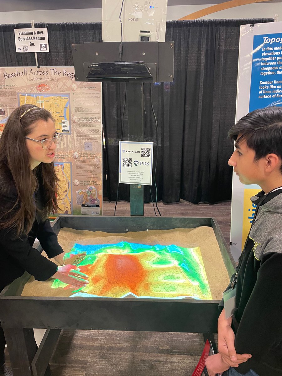 HillYeah7's tweet photo. PDS and the #GIS team are engaging with students about career paths at the NKY Convention Center for the Inspire To Hire event. Having an interactive augmented reality sandbox to talk about #planning and #geospatial industries helps!!! #nky #career #jobs #SARndbox https://t.co/iVd9FXmdIX