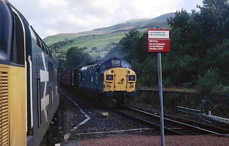 PJSRail's tweet photo. @74frankfurt @PickGS Magnificent - remember them well from numerous trips in the 1980s. Note also another mixed freight in Rannoch station. I’ve just ferreted in the Stanford archives from 1 of my Scottish trips. #Cl37 #Tractor #Englishelectric #Speedlink #ScotRail #WHL Trip ex Glen Douglas. https://t.co/qe0CLgzsXh