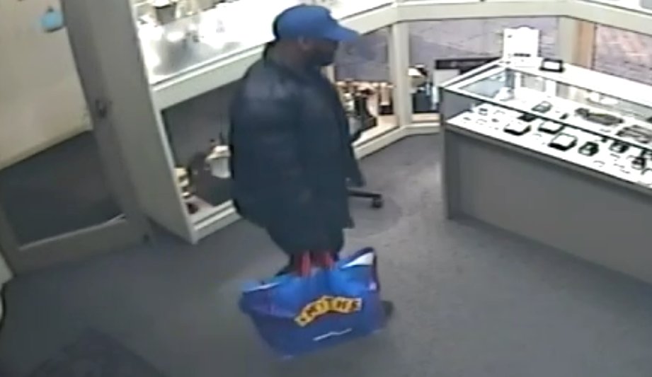 The suspect is described as a black male, about 5ft 7in tall, of medium build with a short, trimmed beard. He was wearing a blue baseball cap and a black jacket, black trousers and black trainers. Witnesses said he may have had one or two gold teeth. Call police on 0161 856 9790.