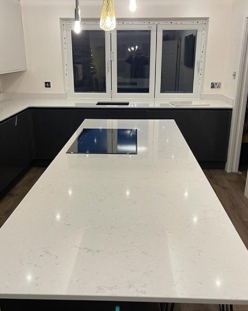 We love the elegance of Cambria Swanbridge quartz with its grey flecks on a white background.  It looks beautiful on this large kitchen island #mycambria