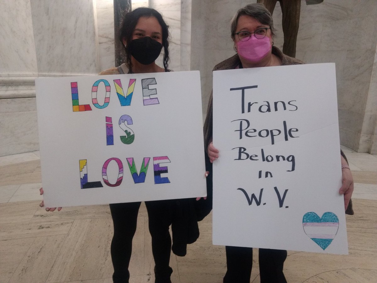 Ircillo's tweet photo. Some other poster havers today, @MarlyDubVee & @sithiaditu (and others!) Are proudly chanting and waving their posters in solidarity with thrans folk of wv! #wvprotest #WVLegis https://t.co/tWYzS5OtBQ