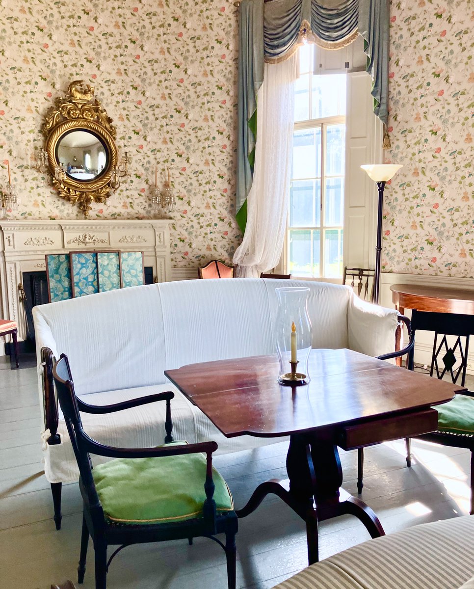 This is the Oval Withdrawing Room inside the Mansion. While this room has many interesting collection items, the shape of the room is one of the room’s most intriguing features.

#AltText The room has painted wooden floors, detailed wallpaper, a fireplace, and lots of seating.