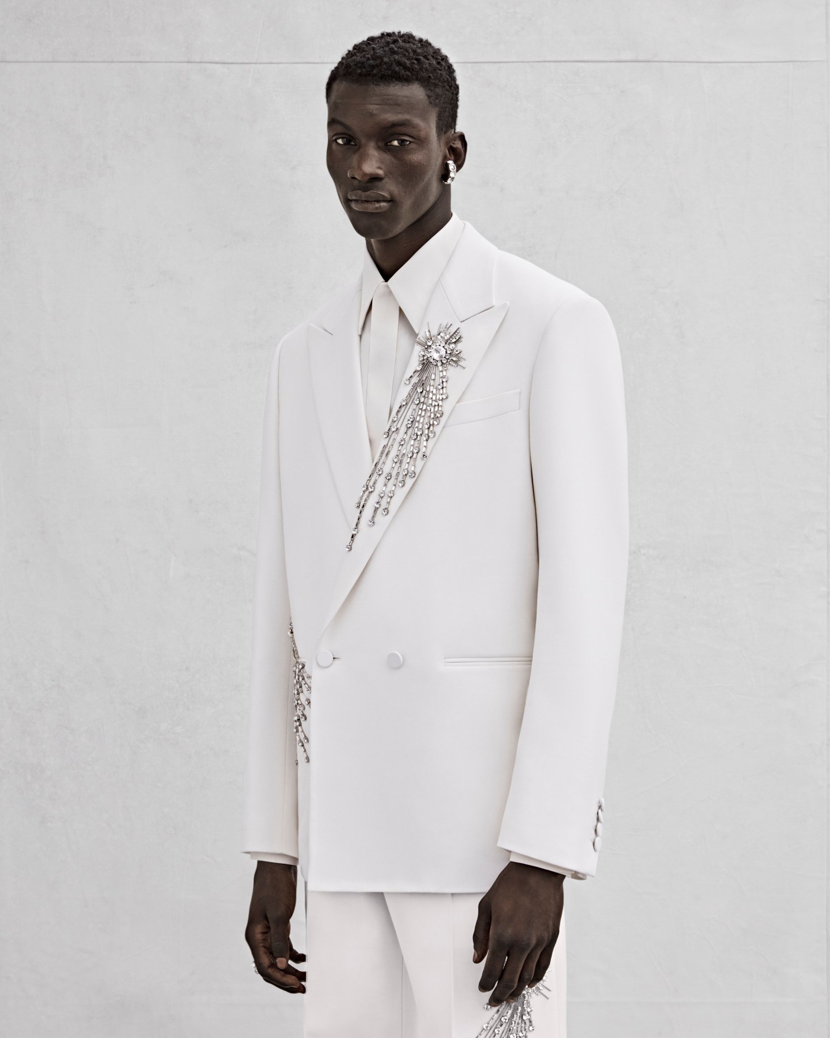 Alexander McQueen on X A white oversized double breasted tailored jacket and wide legged trousers with silver sequin and crystal astral embroidery for Spring Summer 2023 Mens. Discover the McQueenMenS...
