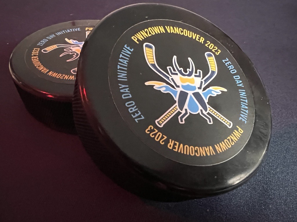 Wow! It took the <a href="/Synacktiv/">Synacktiv</a> team less than two minutes to demonstrate their exploit of the #Tesla Gateway. If confirmed, they will win $100,000 and a Tesla Model 3 (plus these cool hockey pucks). #Pwn2Own #P2OVancouver