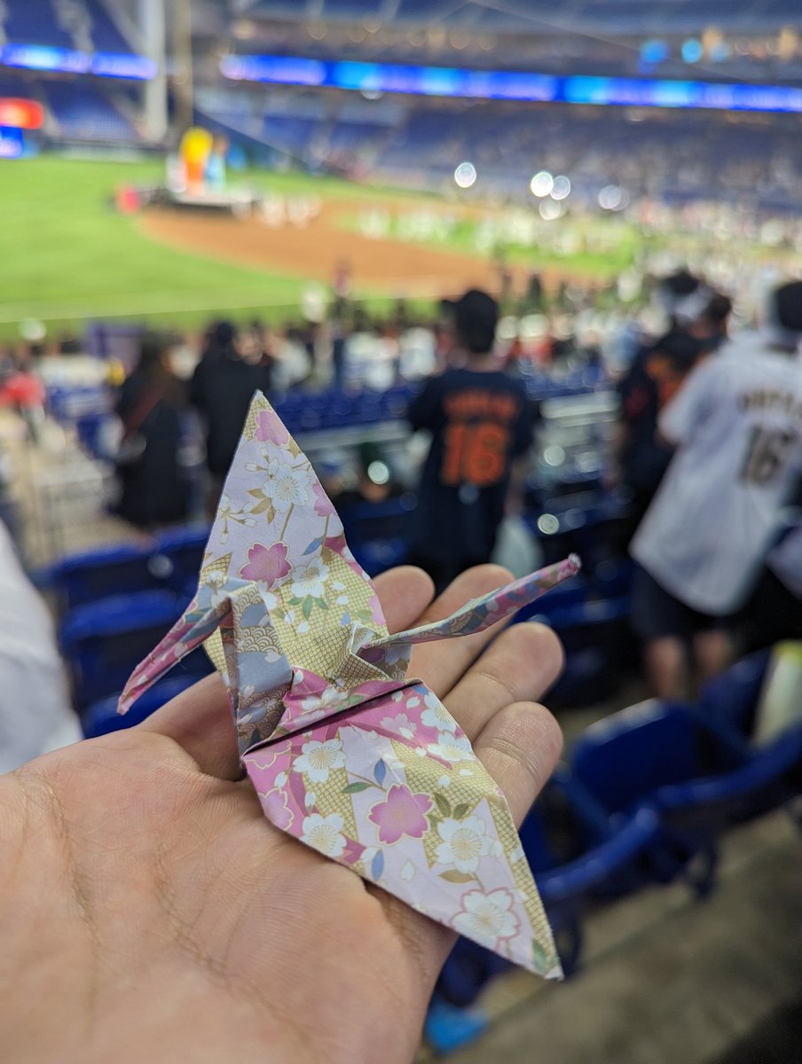 Jacob_Rogers's tweet photo. After the game I took a picture for this man and his wife. As a thank you, he gifted me his origami and traded bandanas with my friend. He made us feel like we were his friends and we celebrated Japan together. Baseball is the best! @SlangsOnSports @Shawn_Spradling #WBC https://t.co/xE1JFcxtpR