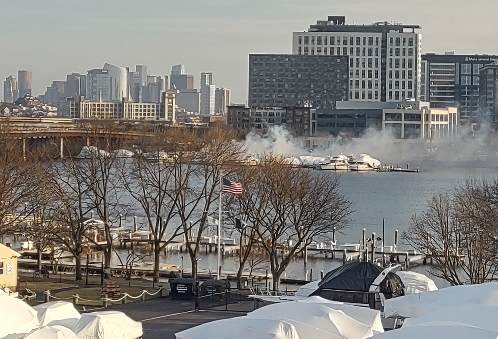 My view from Wellington Station garage of the reported boat fire on the Mystic River near Assembly and the bridge where an Orange Line train caught fire several months ago.