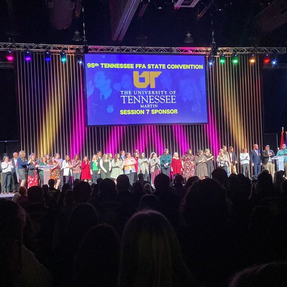 SkyhawkAggie's tweet photo. ‘@utmalumni, mostly High School Ag. Teachers, on stage today at the @tnffa Convention showing the impact of @utmartin on Agricultural Education around the state. #beUTMproud #UTMlovesFFA #TeachAg https://t.co/POQfPCePyW